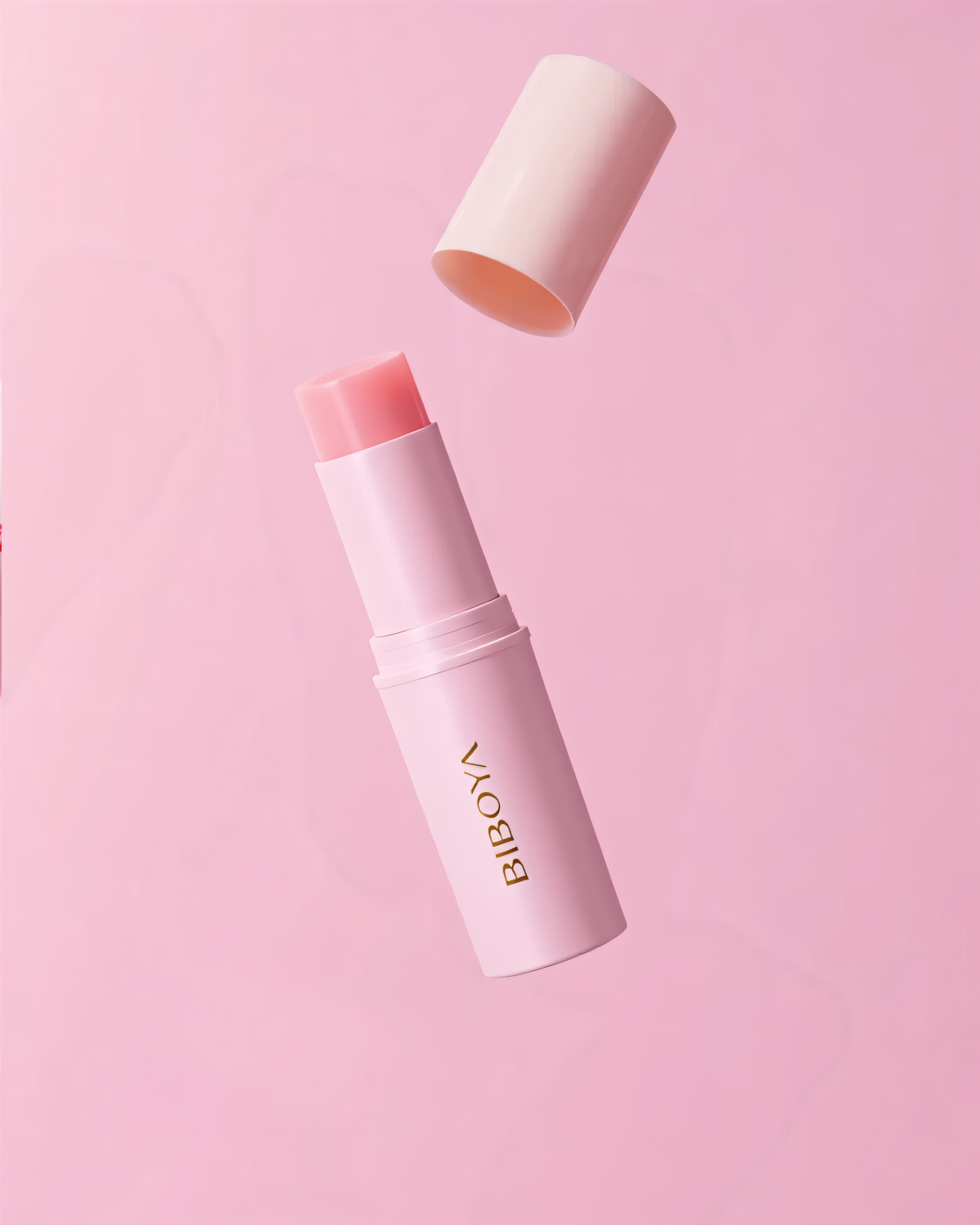 Pink lip balm with cap on a pink background